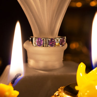 18k white gold ring with natural alexandrite gemstones and baguette diamonds, showcasing a color-changing effect.